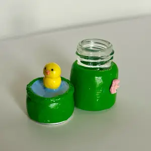 Duck in Pond Themed Glass Jar with Yellow Duck Floating in Water Design Green Container