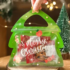 Christmas Toys 50 Holiday Christmas Gift Bags with Green Handles - Durable Plastic Gift Bags for Candy, Chocolate and Cookies - Santa Claus, Christmas Tree and Snowflake Design - Perfect for Christmas Eve Snacks, Candy Christmas Decorations