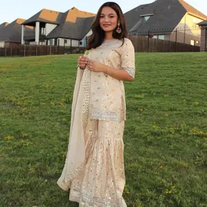 Royal embroidered beige sharara set, featuring delicate floral accents paired with a flowy dupatta and flare pants for a regal finish