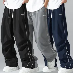 Loose Fit Men's Trousers with Grey Side Stripes and Gold Trim Stripes Comfortable Design Sports and Casual Style Bottoms Sweatpants Fitness Wear Fashionable and Versatile
