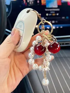 New pearl string cherry keychain cross-border fashion acrylic cherry car keychain high-end sense bag