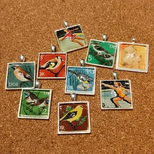 Square pendants, various designs! Comes with a leather cord!