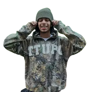 This 'TTUPO' camouflage jacket perfectly blends the ruggedness of workwear with streetstyle flair. Pair it with black leggings and sneakers for a relaxed, casual street style.