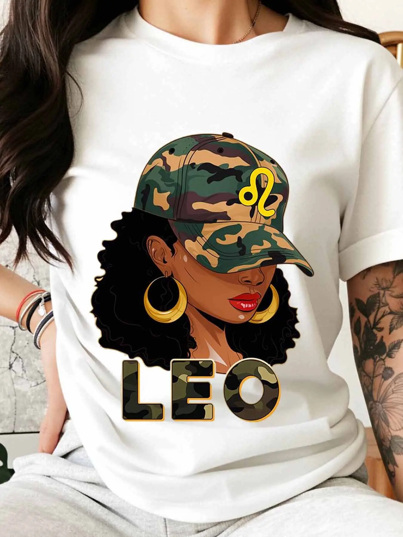 A Leo woman's camouflage baseball cap and gold earring T-shirt   of the day  is suitable for casual and sporty wear. A Leo astrological print T-shirt, featuring a camouflage cap and hoop earrings, is also suitable for casual and sporty wear, Tops, Fits