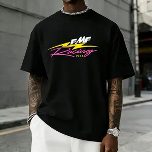 Men’s FMF Racing 1973 graphic T-shirt featuring a retro pink/yellow lightning logo print, made from a soft cotton blend—perfect for motocross fans, streetwear enthusiasts, and casual motorsport-inspired outfits.