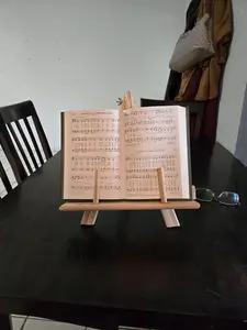 A book easel is a stand or support designed to hold a book upright and open—perfect for reading, displaying without using your hands.
