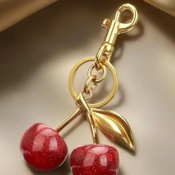 The charm of bag accessories with cherry design. Fashionable keychains for wallets are fashionable, versatile and exquisite for girls. They are charming as birthday gifts, wallet accessories and delicate keychain ornaments.