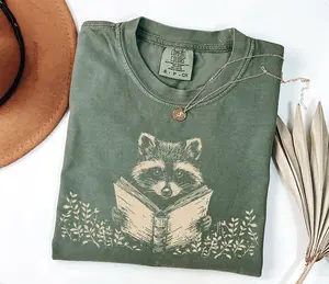 Raccoon Reading Shirt, Book Reader Gift, Bookish Shirt, Cute Racoon Animal Comfort Colors Tee, Womens T-Shirt, Librarian, Book Lover Gift - LORA ATCHER
