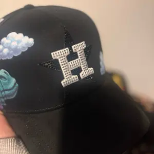 H DY sad 1. Black Baseball Cap with Rhinestone H Logo and Cloud Design