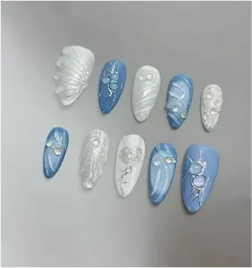 Silver blue 3D press-ons, custom handmade faux acrylics with a gel finish, offering a stylish and unique manicure look.