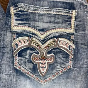 Light Blue Storage Denim Jeans with Unique Embroidered Pocket Design and Distressed Look