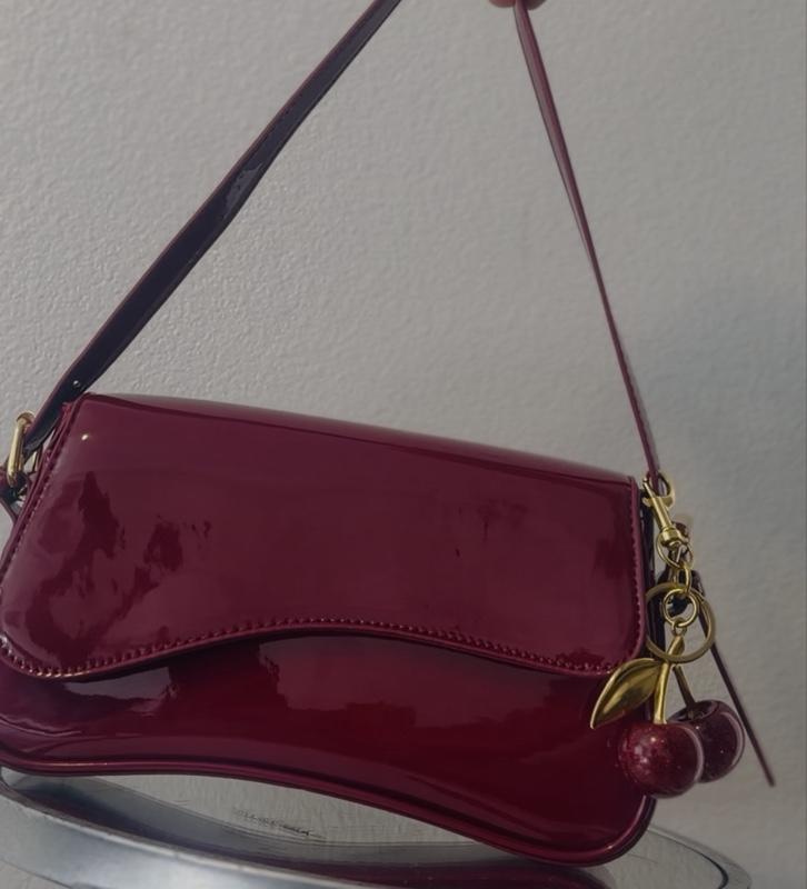 Elegant Red Patent Leather Crossbody Bag with Gold Cherry Charm and Adjustable Strap