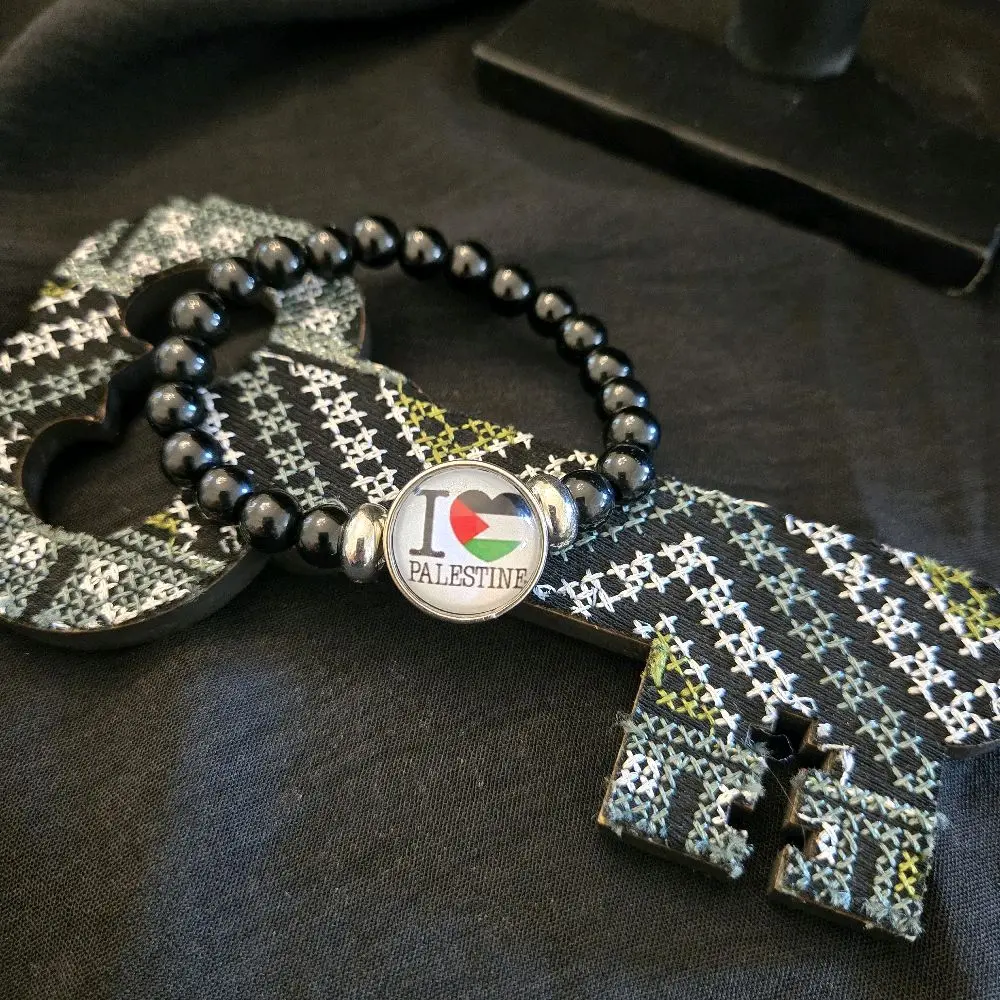 Black Beaded Bracelet with I Love Palestine Heart Charm Featuring Palestinian Flag Design