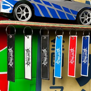 StayTuned Woven Jet Tag Keychain – Premium Woven Logo + Embroidered Edge