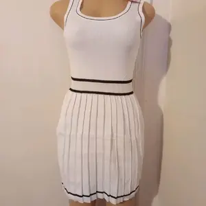 Women's White Pleated Mini Dress with Black Trim and Round Neckline