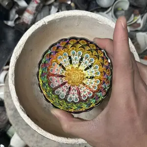 Handmade Jianzhan teacup, exquisitely carved with lotus flowers and hand-painted with peacock feathers—a unique design.