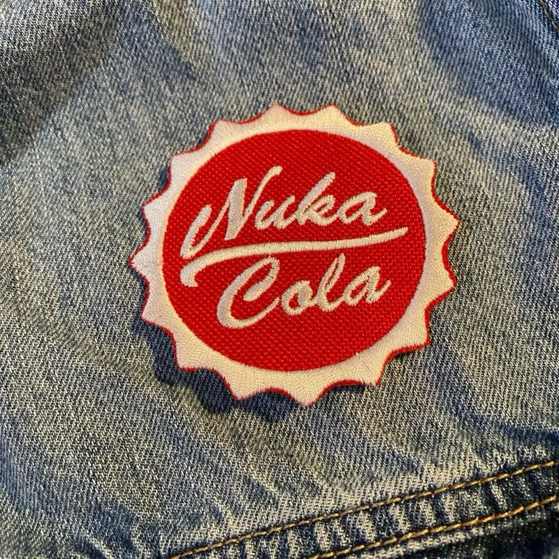 Fallout Nuka-Cola Logo Patch (1 Count), 2.88in Unique Embroidery Sewing Accessory, Durable Stitching, Sew-On-Iron-On-Hook Backing, High-Quality Fabric Trim for Fallout Enthusiasts’ Cosplay Costumes & Custom DIY Projects, Retro Flair for Jackets, Bags