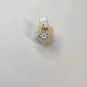 Daisy with light yellow poof USBc dust plug protector