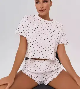 A woman in a two-piece cotton short-sleeved shirt and short pants set in pajamas