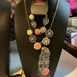 Paparazzi set that has 3 pieces. Necklace, and 2 types of bracelets . This set features a beautiful pink rose on each piece.