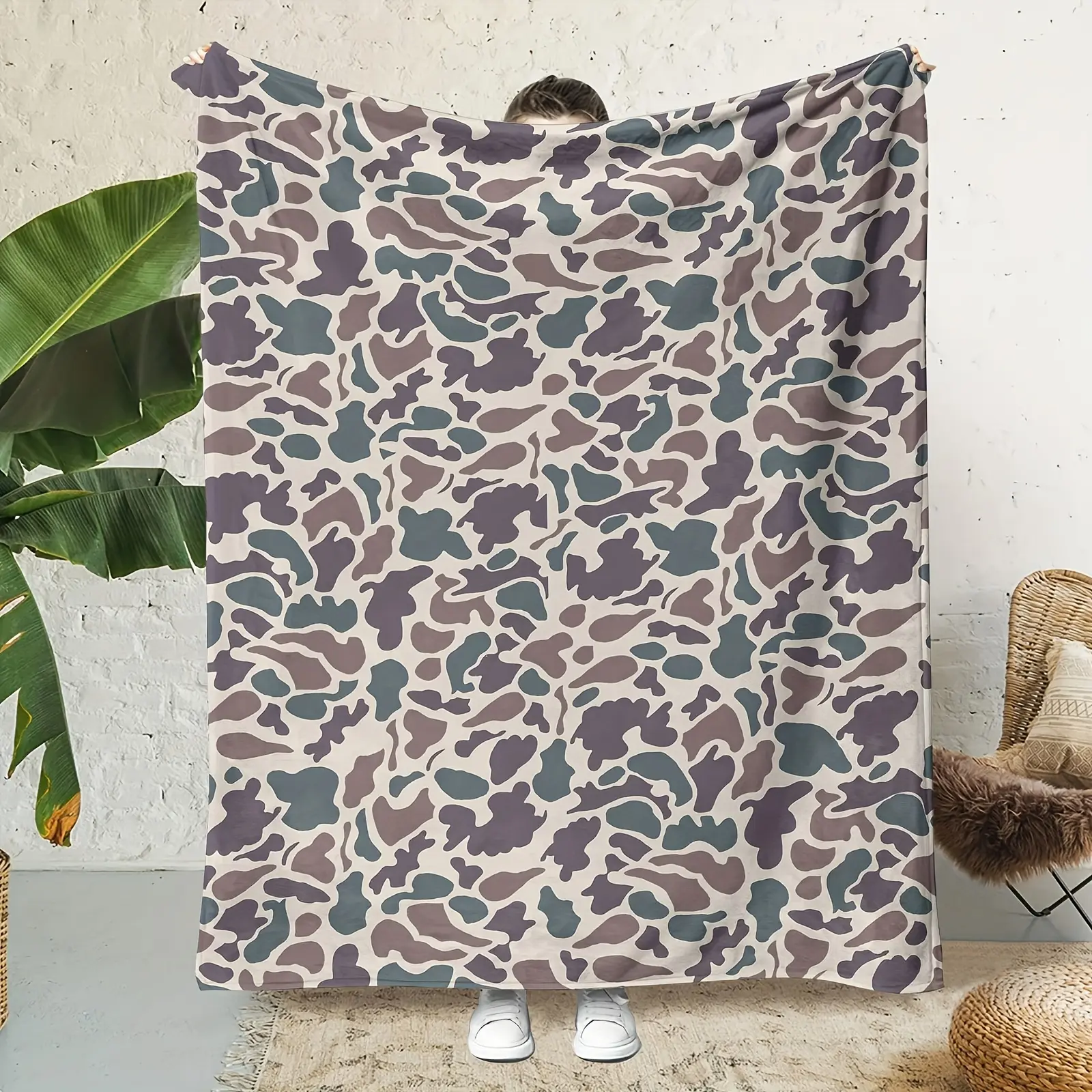 Comfortable camouflage printed flannel blanket - soft, warm, and lightweight, suitable for all seasons, featuring a dense forest pattern in green, gray, black, white, and brown.