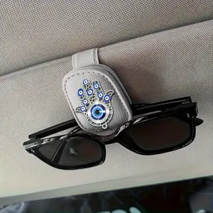 A Golden And silvery Demon Eye Car Sunshade Glasses Clip, Featuring a Creative Metal Lucky Hand Decoration, Universal Faux Leather Glasses Clip, Card Holder, And Glasses Storage