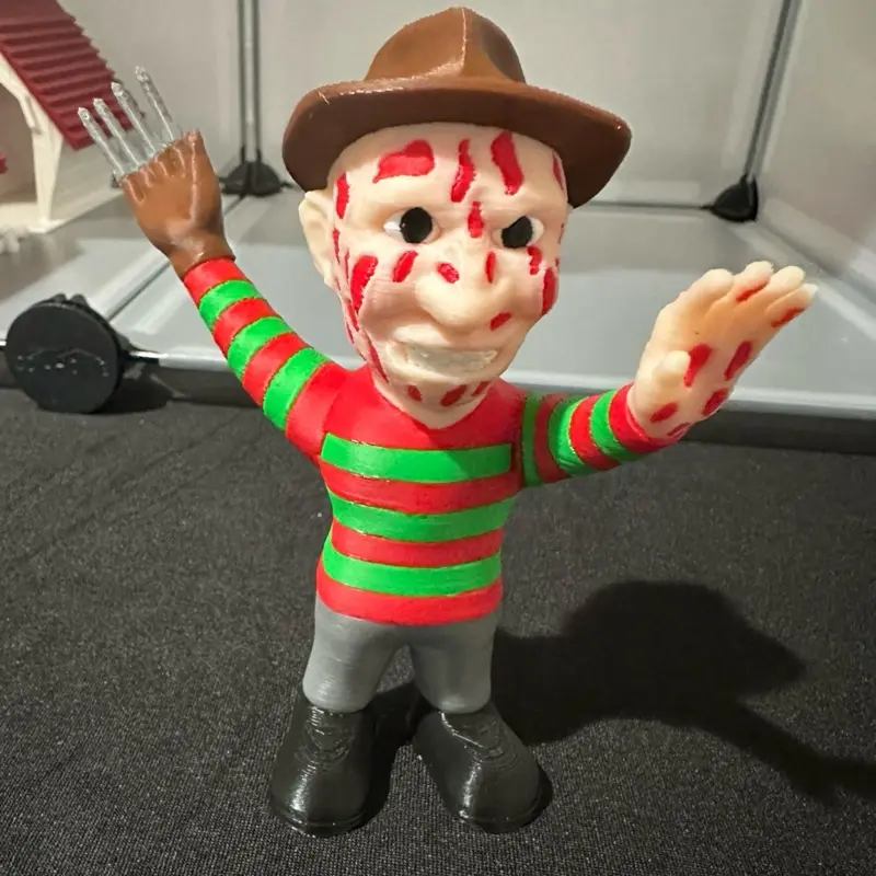 Freddy Krueger Classic Horror Action Figure 5 Inches Tall with Iconic Red Green Striped Shirt Grey Pants Brown Hat Collectible Toy for Horror Fans