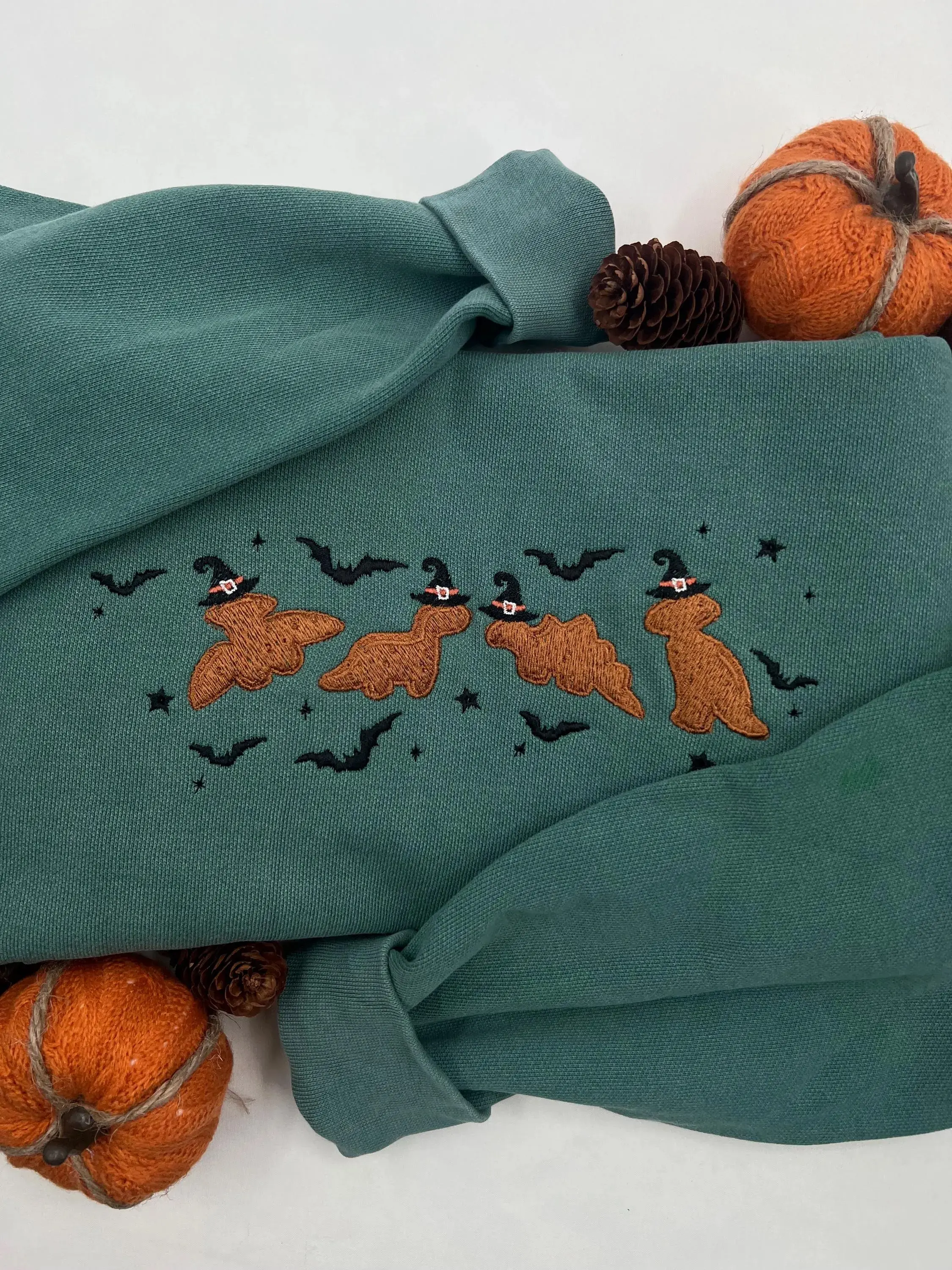 Magical Dino Nuggets Sweatshirt | Spooky Season Embroidered Halloween Apparel | Cozy Fall Sweater with Witchy Dino Design | Soft Cotton Blend | Perfect for Halloween Festivities and Everyday Wear | Durable and Machine Washable