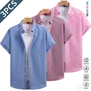 Three plaid men’s short-sleeve shirts in a business-casual style featuring a classic notched collar design that is sharp and well-structured. A pink-and-white plaid contrast collar adds refined details, while white front buttons enhance the texture. The s