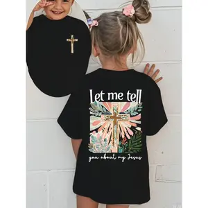 Colorful Graphic Black T-Shirt for Girls - Features Floral Cross Design and Inspirational 'Let me tell you about my Jesus' Text |   Adorned with Pink Hair Clips, Perfect for Casual Wear |   Stylish and Eye-Catching Top for Young Fashionistas