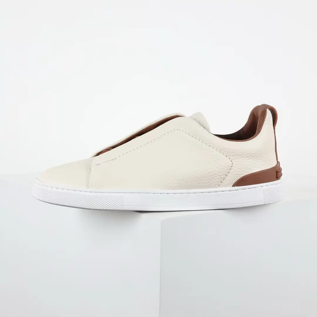 Cream Brown Color Block Slip-On Leather Sneakers Soft Pebbled Cowhide Upper Thin Brown Collar Lining Sweat Resistant Fabric Insole Light Flat Cushion White Rubber Sole For Office Business Attire & Minimal Daily Casual Outfits