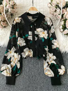 A black floral-printed, button-down, long-sleeved, Fitted blouse for ladies, exuding elegant style and suitable for all kinds of formal occasions.