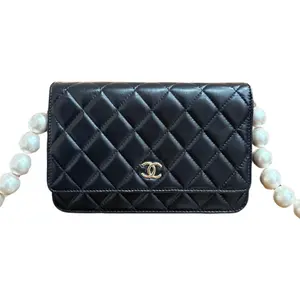 Pre-owned CHANEL lambskin Crossbody Bags Classic WOC in Black Quilted with Gold Tone CC Turnlock and Pearl Chain Strap