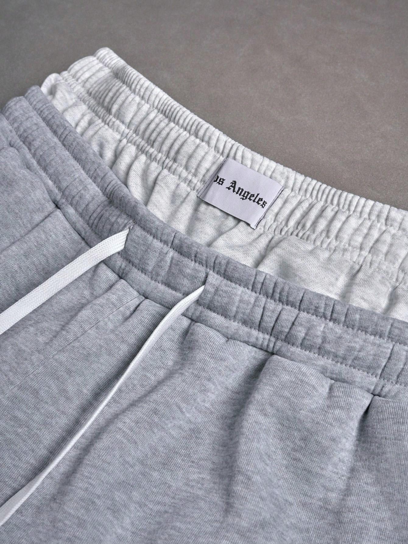 Gray sweatpants with embroidered logo, Y2K American street casual joggers, loose casual knitted sports pants featuring a drawstring and faux two-piece design with contrasting double waistband, perfect for everyday wear and trendy gatherings.
