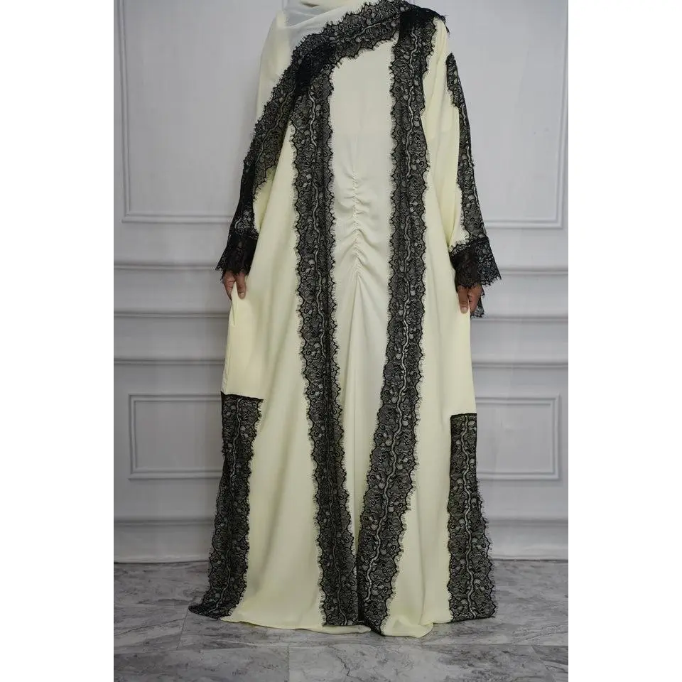 Beautiful flowy abaya with pretty black lace detailing on the front, sleeves, and sides. It has a relaxed fit with a cute gathered detail in the front that gives it a little extra something.