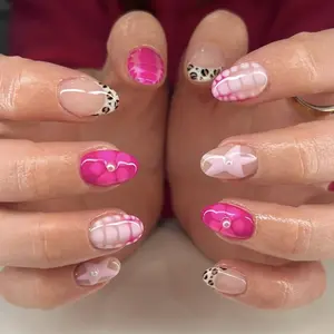 Short almond-shaped nail tips with removable rose-pink floral and star designs