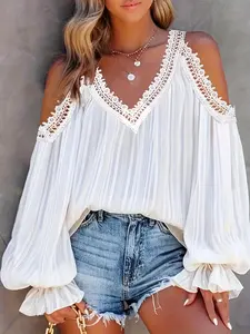 A women's white patchwork lace long-sleeved blouse, loose-fitting and versatile, ideal for casual and laid-back styles.