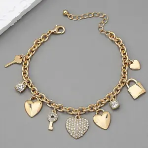 Gold Heart Pendant Bracelet — An exquisite gold bracelet for women, featuring a delicate chain design adorned with heart and key-lock pendants. A romantic piece of jewelry crafted with a gold-plated finish—an ideal gift choice.