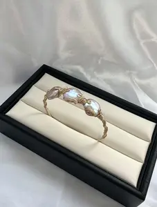 Bangle01-Wire-Wrapped Freshwater Pearl Cuff Bracelet Bangle With Twisted Band Detail #pearlbracelet #freshwaterpearl #wirewrappedjewelry #pearljewelry #bohostyle #statementbracelet #pearlcore #jewelryfinds #giftideas #braceletstack #fashionjewelry