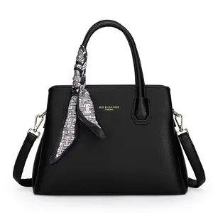 Luxurious black structured genuine leather new fashionable handbag adorned with an elegant silk scarf, offering versatile ways to wear it—perfect for commuting, everyday office use, casual outings, and parties.