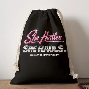 She Hustles. She Hauls. Built Different. Drawstring Bag