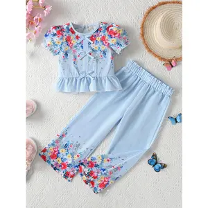 A Two-Piece Set Girls, Featuring a Outfit with a Short-Sleeve Shirt Adorned with a Bow And Floral Prints, Paired with Casual Loose-Fitting Long Pants, Perfect Holiday Trips And Everyday Outings, Outdoor