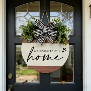 Rustic Round Wooden Welcome Sign for Front Door - Farmhouse Porch Decor with Black & White Striped Bow, Greenery, and "Welcome to Our Home" Text - 12 Inch Hanging Wall Decor for Entryway, Housewarming Gift