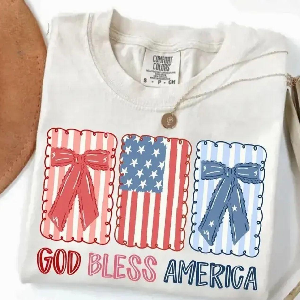 God Bless America Comfort Colors Shirt, Patriotic Bow Graphic Tee, Fourth of July Americana Shirt, USA Flag Coquette T-Shirt, Trending 4th of July Day Tee, Casual Outfit, Comfortable Menswear & Womenswear Top, Perfect Gift For Men and Women, Ju9