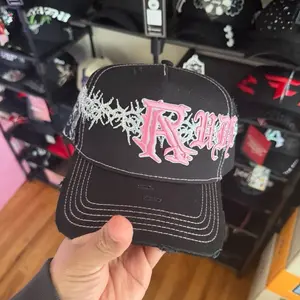 Rude Distressed Black Trucker Hat with Pink Embroidered Logo and White Stitching for Urban Style
