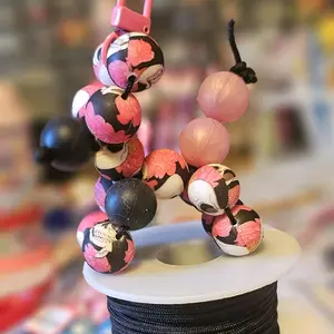 Shop Live: Product with Live Description and Image Featuring Unspecified Items and Colors Including Colorful Beads and Black Rope