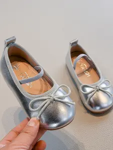 "The absolute CUTEST metallic ballet flats for your mini-me! The elastic strap is a game-changer for independent dressing, and they literally make every outfit pop! Which color do you need?  Link in bio! "