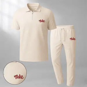 Men's two-piece set features a short-sleeve zip-collar polo shirt and matching trousers. Crafted from breathable, soft-textured waffle-knit fabric, it offers a comfortable, relaxed fit ideal for everyday casual wear.
