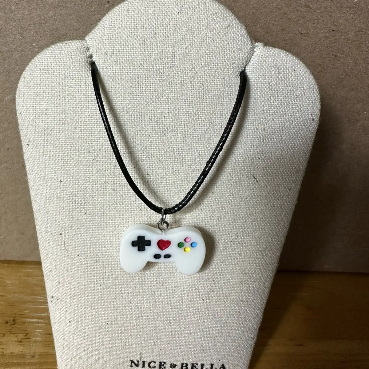 Black leather necklaces with game controller pendant.
