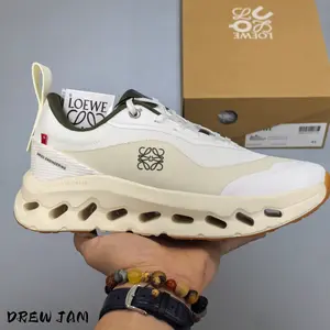Streetwear cloud athletic kicks carry warm earth neutral minimalist urban vibe, blending sweat-wicking thin knit mesh and hollow wave segmented cushion outsole, white-sand color blocking with olive accents, grippy foam sole